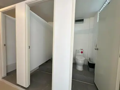 a bathroom with a toilet and a door open at Blue Horizon Hostel By Blue Flow in Phi Phi Don