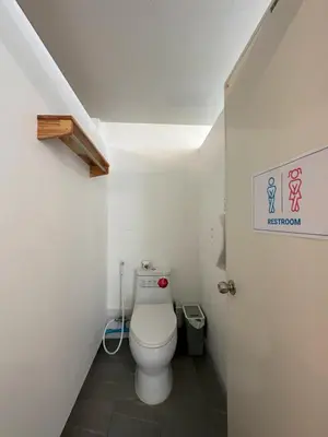 a bathroom with a white toilet in a room at Blue Horizon Hostel By Blue Flow in Phi Phi Don