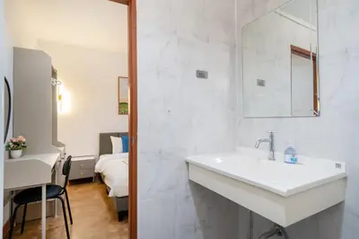 a white bathroom with a sink and a bedroom at Patong private home 4BR Jazzuci sleep 10 in Patong Beach