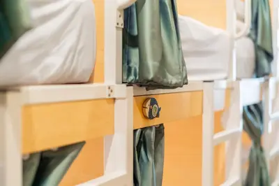 a shelf with green and white bags on it at Sweett Lemon Hostel in Patong Beach