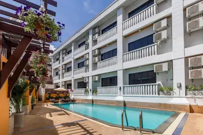 an image of an apartment building with a swimming pool at Rattana Karon Beach Hotel in Karon Beach
