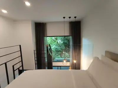 a bedroom with a white bed and a window at Utopia Naiharn - Room3 - B124 in Rawai Beach