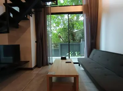 a living room with a couch and a coffee table at Utopia Naiharn - Room3 - B124 in Rawai Beach