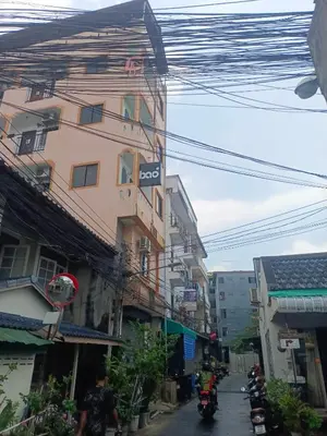 a group of motorcycles driving down a street with buildings at XX Bao Patong Beach PHUKET เบา หาดป่าตอง ภูเก็ต in Patong Beach
