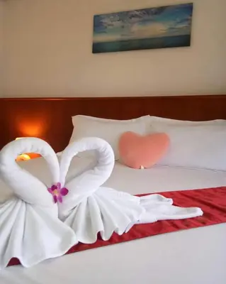 two swans made to look like hearts sitting on a bed at Kata Goran in Kata Beach