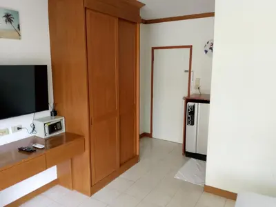 a living room with a television and a kitchen at Kata Goran in Kata Beach