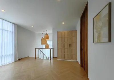 a room with a hallway with a door and a table at Bangtao Luxury Pool Villa - PrymaVerde in Laguna Phuket