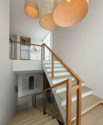 a staircase with wooden railings and spherical lights at Bangtao Luxury Pool Villa - PrymaVerde in Laguna Phuket