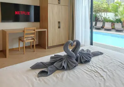 two towel swans on a bed in a hotel room at Bangtao Luxury Pool Villa - PrymaVerde in Laguna Phuket