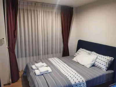 a bedroom with a bed with towels on it at Centrio Phuket C3 in Ban Rangeng