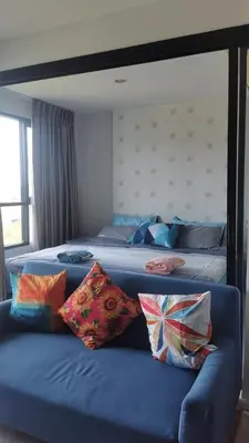 a bedroom with two beds with pillows on a couch at Centrio Phuket C3 in Ban Rangeng
