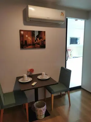 a dining room with a table and two chairs at Centrio Phuket C3 in Ban Rangeng