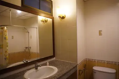 a bathroom with a sink and a toilet and a mirror at Centre Point Nanai in Patong Beach