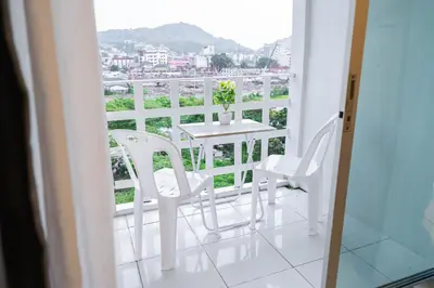 a balcony with a table and chairs and a view at Mama's Cozy Studio - Patong Beach in Patong Beach