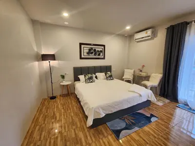 a bedroom with a bed and a table and chairs at Mama's Cozy Studio - Patong Beach in Patong Beach