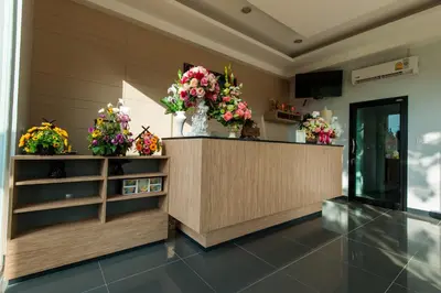 a flower shop with flowers in vases on a counter at Jinda Resort in Nai Yang Beach
