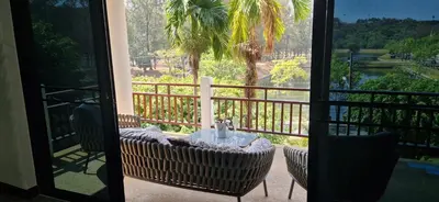 a balcony with a table and chairs and a view at Two bedroom apartment near Naiharn beach in Nai Harn Beach