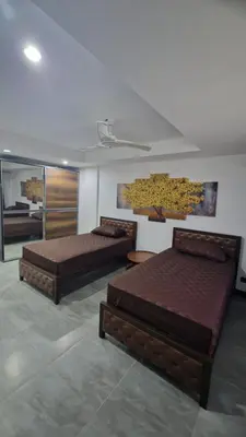a room with three beds in a room at Two bedroom apartment near Naiharn beach in Nai Harn Beach