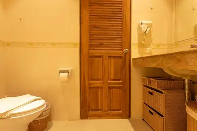 a bathroom with a toilet and a sink at Cozy 1BR Poolside Apartment with Scenic Balcony C132 in Surin Beach