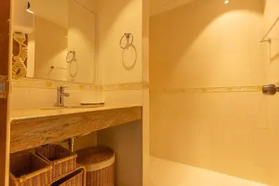 a bathroom with a sink and a shower at Cozy 1BR Poolside Apartment with Scenic Balcony C132 in Surin Beach