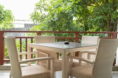 a white table and chairs on a balcony at Cozy 1BR Poolside Apartment with Scenic Balcony C132 in Surin Beach
