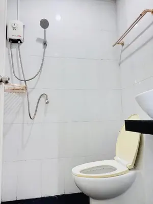 a bathroom with a toilet and a shower at KLApartment in Ban Bang Chak