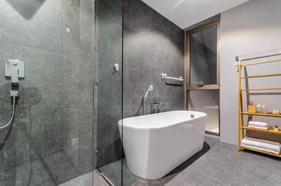 a bathroom with a tub and a glass shower at Modern Pool Villa in Chalong in Chalong