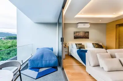 a bedroom with a bed and a couch at Modern Pool Villa in Chalong in Chalong
