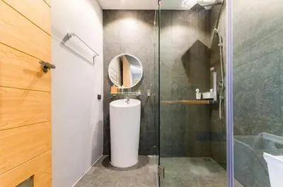 a bathroom with a toilet and a glass shower at Modern Pool Villa in Chalong in Chalong