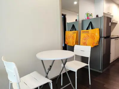 a table and two chairs next to a refrigerator at Rawai Beachfront - Studio room on 2 floor in Rawai Beach