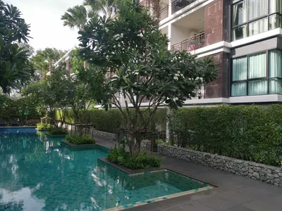 a swimming pool in front of a building at Rawai Beachfront - Studio room on 2 floor in Rawai Beach