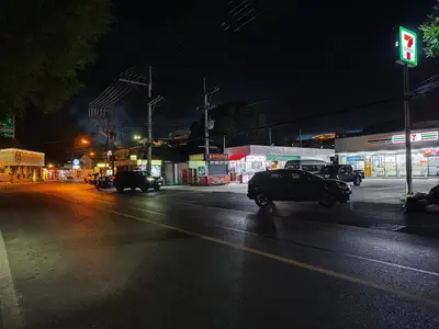 a city street at night with a green traffic light at Rawai Beachfront - Studio room on 2 floor in Rawai Beach