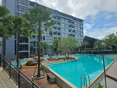 a large swimming pool in front of a building at 1BDR 2 Pools on the roof 500m to beach 3 Bars in Kamala Beach