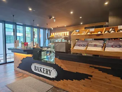 a bakery with a display case in a store at 1BDR 2 Pools on the roof 500m to beach 3 Bars in Kamala Beach