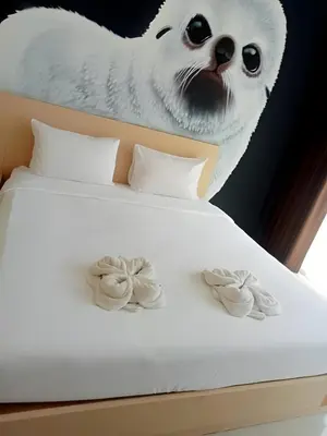 a bed with a cat head and two cookies on it at xx GO INN Ao Nang Krabi - โกอินน์ อ่าวนาง กระบี่ Aonang in Ban Khlong Haeng