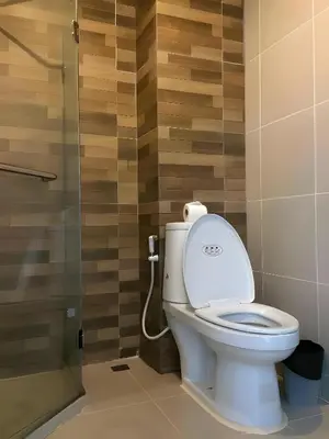 a bathroom with a toilet and a glass shower at xx GO INN Ao Nang Krabi - โกอินน์ อ่าวนาง กระบี่ Aonang in Ban Khlong Haeng
