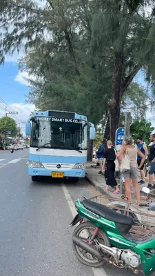 a bus is parked on the side of the road at Rawai beach condominium \u62c9\u8587\u6d77\u6ee9\u9152\u5e97\u516c\u5bd3 in Nai Harn Beach