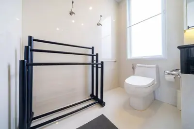 a bathroom with a toilet and a window at Patong WiN HOUSE Villa in Patong Beach