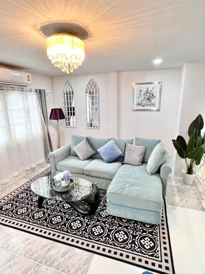a living room with a couch and a table at Comfort Home Patong in Patong Beach