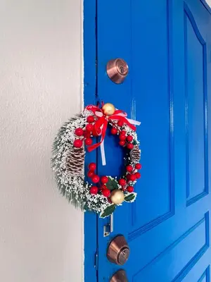 a wreath is hanging on a blue door at Comfort Home Patong in Patong Beach