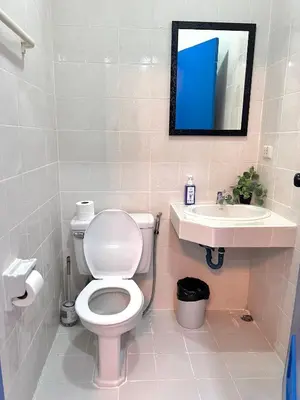 a bathroom with a toilet and a sink at Comfort Home Patong in Patong Beach