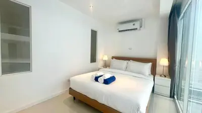 a bedroom with a bed with a blue box on it at Sunset Plaza Condominium in Karon Beach