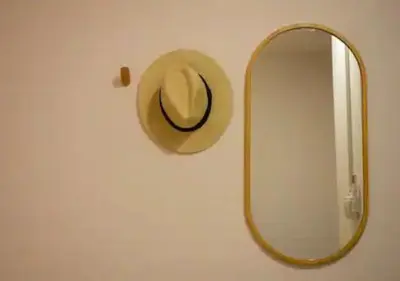 a hat on a wall next to a mirror at Mango Moon Phuket Tropical 2BR near Central Phuket in Ban Rangeng