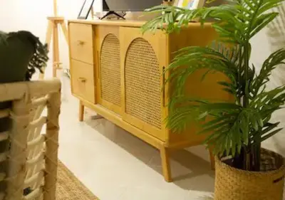 a yellow cabinet with a tv and a potted plant at Mango Moon Phuket Tropical 2BR near Central Phuket in Ban Rangeng