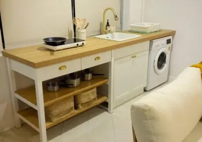 a kitchen counter with a sink and a washing machine at Mango Moon Phuket Tropical 2BR near Central Phuket in Ban Rangeng