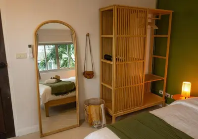 a room with a mirror and a bedroom with a bed at Mango Moon Phuket Tropical 2BR near Central Phuket in Ban Rangeng