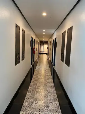a long hallway with doors and a tile floor at Jong's House- Phi Phi Island in Phi Phi Don