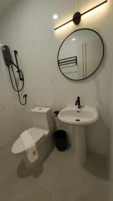 a bathroom with a sink and a mirror and a toilet at Jong's House- Phi Phi Island in Phi Phi Don