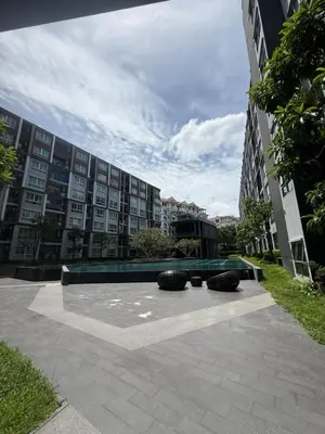 a bench in a courtyard in front of a building at Dcondo mine Kathu Phuket in Kathu