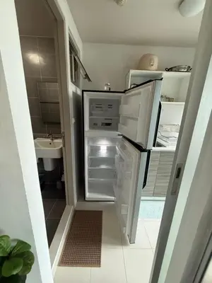 a kitchen with an open refrigerator and a sink at Dcondo mine Kathu Phuket in Kathu